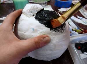 Adding the first layer of paint to the stone