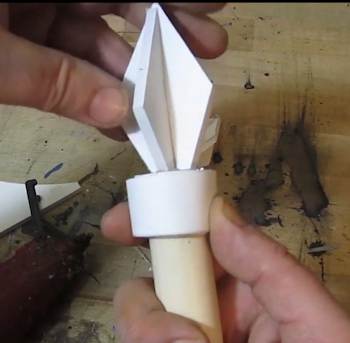 Glue a band and a spike to the end of the dowel