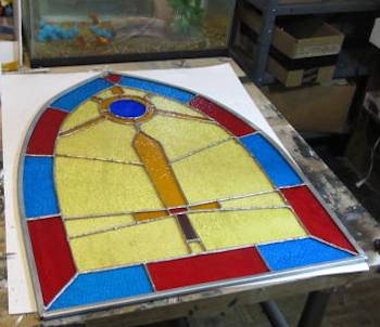 The completed stained glass window with zinc came wrapping it