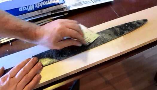 Use emory paper to clean the scale