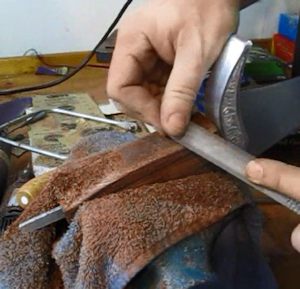 Rasping the wood handle