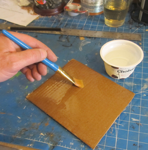 Brush water onto cardboard