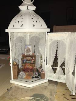 Open the lantern to reveal the diorama
