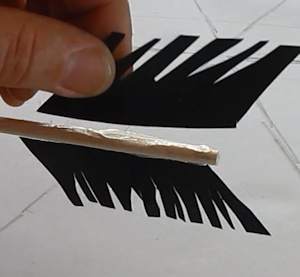 Glue the feathers on