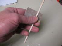 Sand a square piece to make it round like a dowel