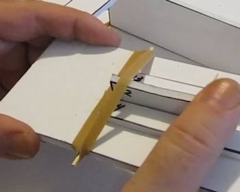 Affix a rubber band over trigger