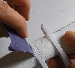 Use the edge of the sandpaper