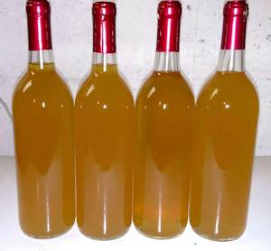 Four bottles of mead with shrink caps