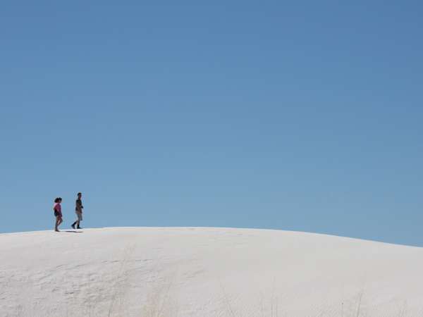A couple walking on the white sands